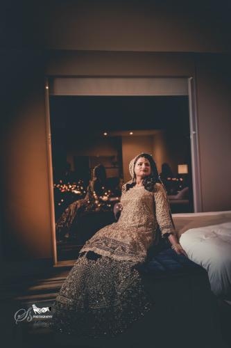 bride posing in wedding dress on bed